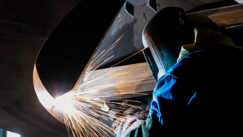 Man welding inside a pipe, highlighting recruitment drive to join the team