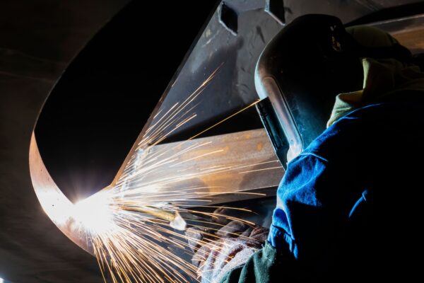 Man welding inside a pipe, highlighting recruitment drive to join the team