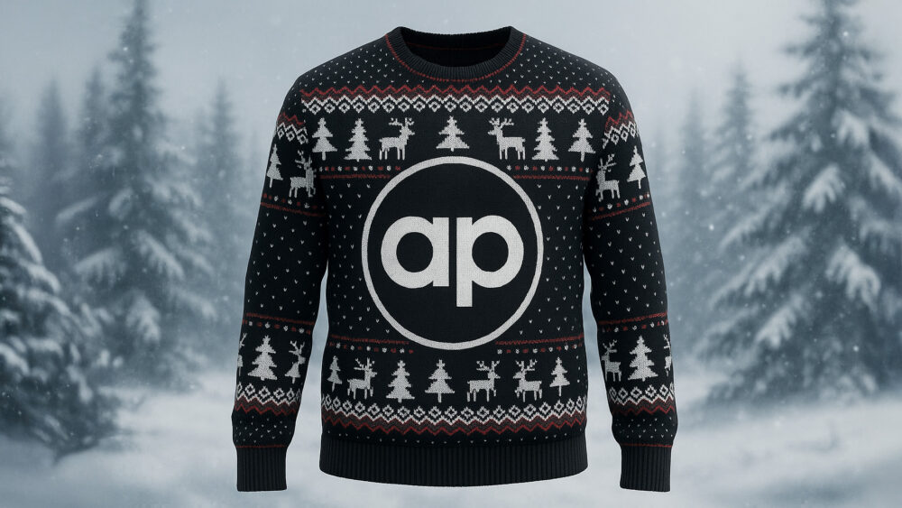 Allied Protek logo on a Christmas jumper with a snowy background.